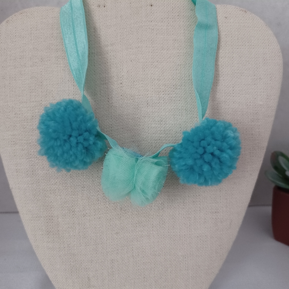 Girls Headband with pompoms.
